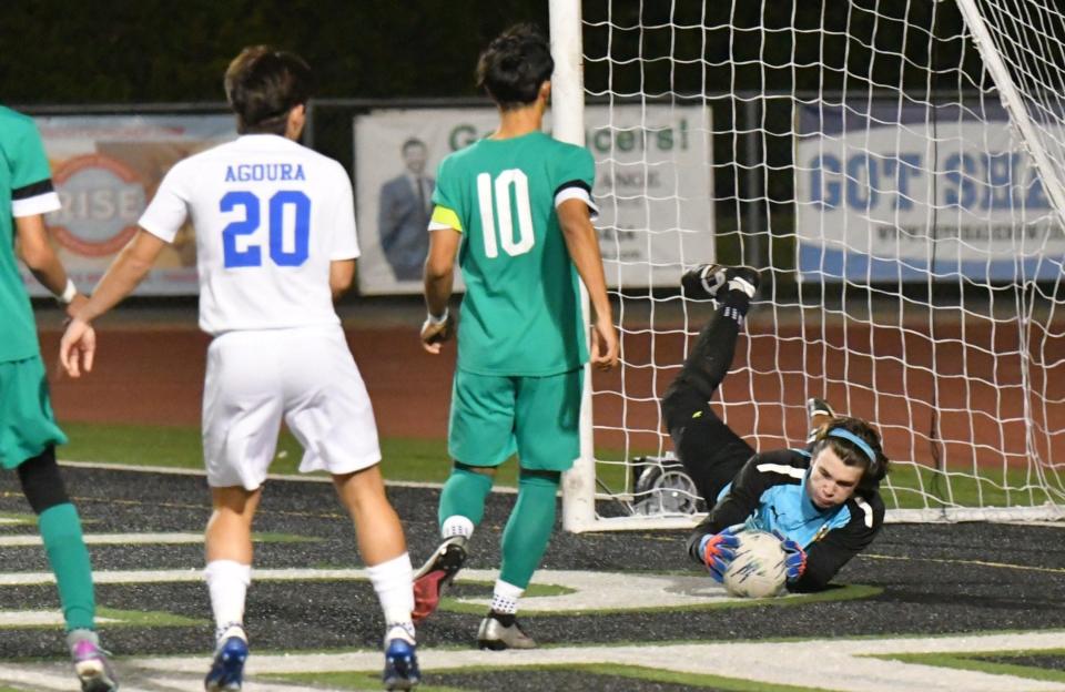 Thousand Oaks High goalie Triston Candon makes a save during the Lancers' 1-0 win over Agoura in a Marmonte League showdown at Thousand Oaks on Tuesday, Jan. 30, 2024. The Lancers clinched the league championship.