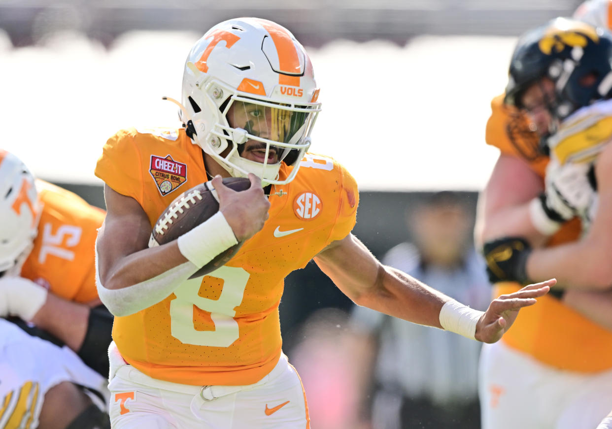 ORLANDO, FLORIDA - JANUARY 01: Nico Iamaleava #8 of the Tennessee Volunteers rushes for a 19-yard touchdown in the second quarter against the Iowa Hawkeyes during the 2024 Cheez-It Citrus Bowl at Camping World Stadium on January 01, 2024 in Orlando, Florida. (Photo by Julio Aguilar/Getty Images)