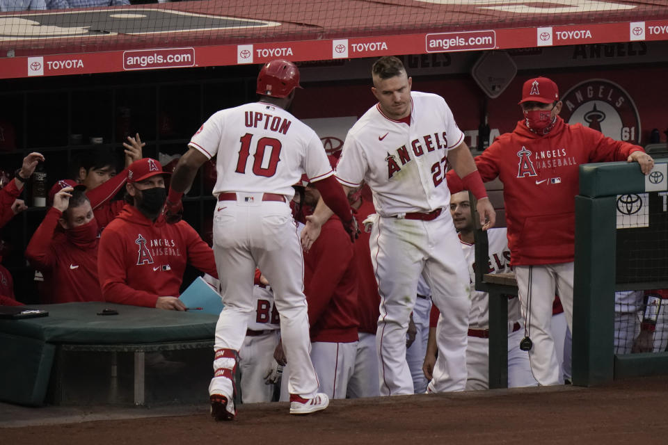 Los Angeles Angels' Justin Upton, left, is congratulated by Mike Trout after hitting a home run during the second inning of a baseball game against the Los Angeles Dodgers, Friday, May 7, 2021, in Anaheim, Calif. (AP Photo/Jae C. Hong)