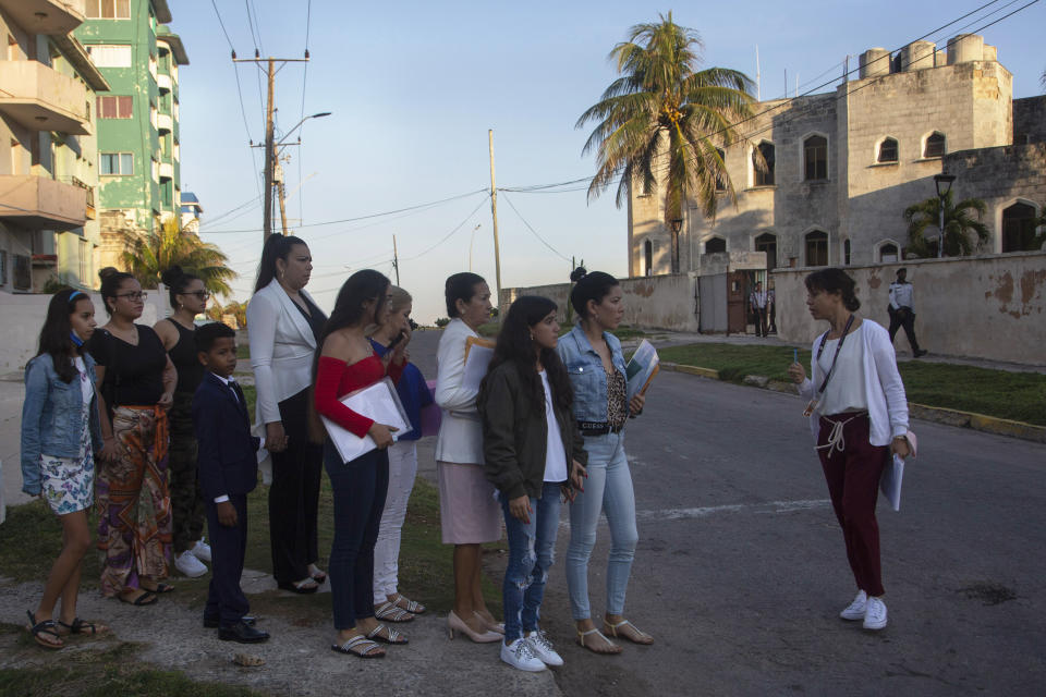 FILE - People wait in a line as they are organized to enter the U.S. embassy on the day of its reopening for visa and consular services in Havana, Cuba, Jan. 4, 2023. Overwhelmed by thousands of Cubans crowding its southern border after making the dangerous trip through Central America and an increase in makeshift boats crossing the Florida Straits, the United States in early January approved a policy change that makes migrants request a permit, or parole, online before arriving with the sponsorship of a relative or acquaintance in the U.S. (AP Photo/Ismael Francisco, File)