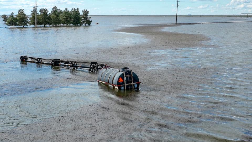 Farm equipment stands in floodwater just South of Tulare River Road.