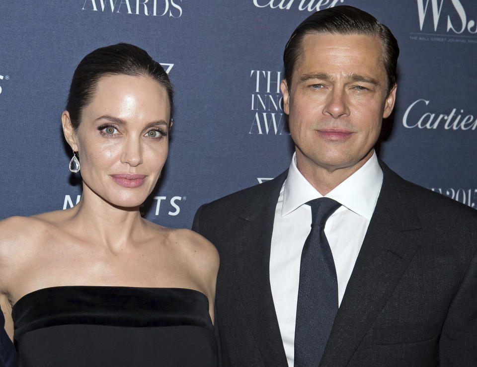 FILE - In this Nov. 4, 2015, file photo Angelina Jolie Pitt and Brad Pitt pose for a photo at the WSJ Magazine Innovator Awards 2015 at The Museum of Modern Art in New York. Jolie criticized a judge deciding on custody arrangements for her and Pitt’s children during their divorce, saying in a court filing on Monday, May 24, 2021, that the judge refused to allow their kids to testify. (Photo by Charles Sykes/Invision/AP, File)