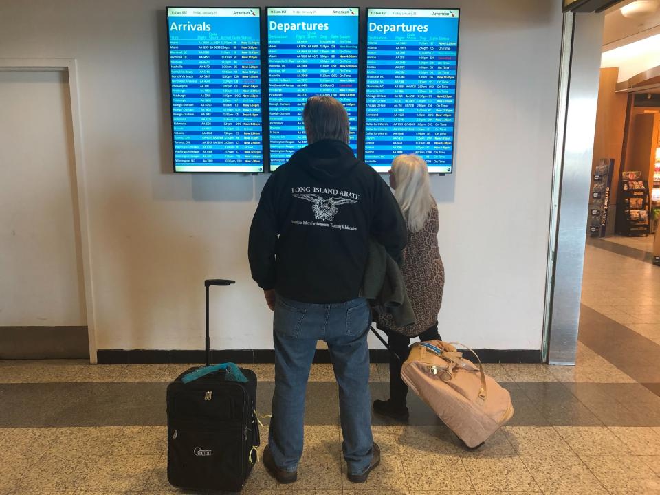 Customers check on flights at LaGuardia Airport in New York, where sweeping delays on Friday were caused by staffing issues with air traffic controllers. (Photo: Alexander Kaufman/HuffPost)