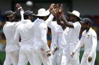 Sri Lanka's Nuwan Pradeep (2nd R) celebrates with teammates after taking the catch to dismiss India's Rohit Sharma (not pictured) during the fourth day of their third and final test cricket match in Colombo August 31, 2015. REUTERS/Dinuka Liyanawatte