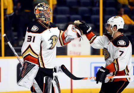 Anaheim Ducks goalie Frederik Andersen (31) is congratulated by center Andrew Cogliano (7) after a win against the Nashville Predators in game three of the first round of the 2016 Stanley Cup Playoffs at Bridgestone Arena. The Ducks won 3-0. Mandatory Credit: Christopher Hanewinckel-USA TODAY Sports