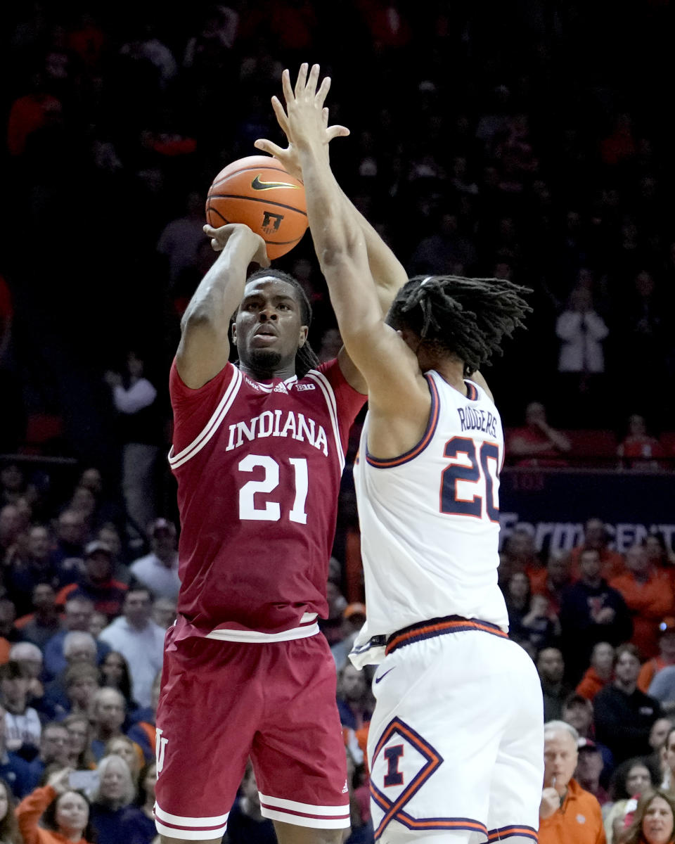 Indiana's Mackenzie Mgbako (21) shoots as Illinois' Ty Rodgers (20) defends during the second half of an NCAA college basketball game, Saturday, Jan. 27, 2024, in Champaign, Ill. Illinois won 70-62. (AP Photo/Charles Rex Arbogast)