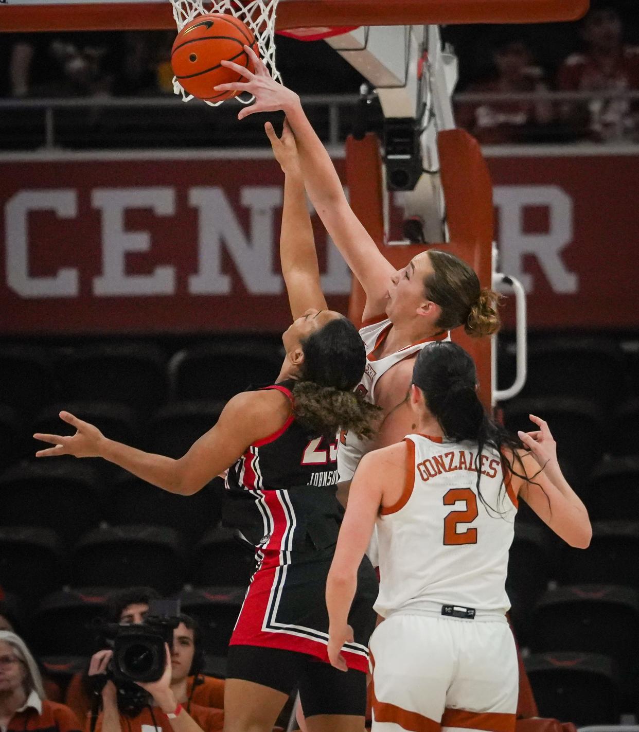 Texas forward Taylor Jones blocks a layup attempt by Texas Tech guard Loghan Johnson during the Longhorns' win at Moody Center on Feb. 21. Jones is one of three 6-footers that top-seeded Texas is likely to start Friday.
