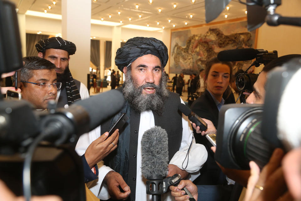 Image: Taliban leader Mullah Abdul Salam Zaeef, center, who served as ambassador to Pakistan during the Taliban's rule speaks to the media in Doha, Qatar