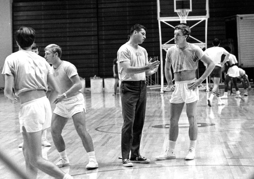 Bob Knight talks to guard Frank Wilson while assistant Dave Bliss works with others in one of Knight's first IU practices in October 1971.