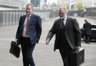 United Kingdom's Brexit advisor David Frost, left, and British Ambassador to the EU Tim Barrow arrive at EU headquarters for a technical meeting on Brexit at EU headquarters in Brussels, Tuesday, Oct. 8, 2019. (AP Photo/Virginia Mayo)