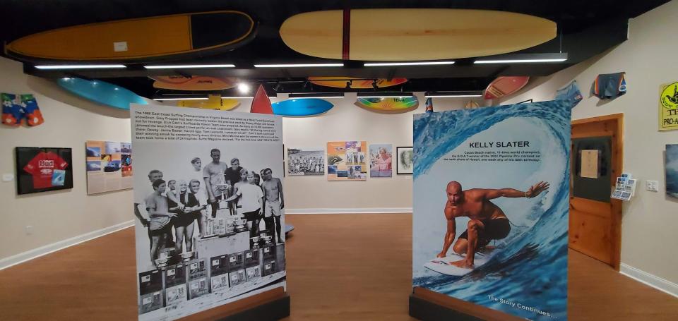 Two large panels, one showing Dick Catri's Surfboards Hawaii Team in 1966 with East Coast champion Gary Propper, and the other showing the exploits of 11-time world champion Kelly Slater, greet guests as they arrive at the Florida Surf Museum.