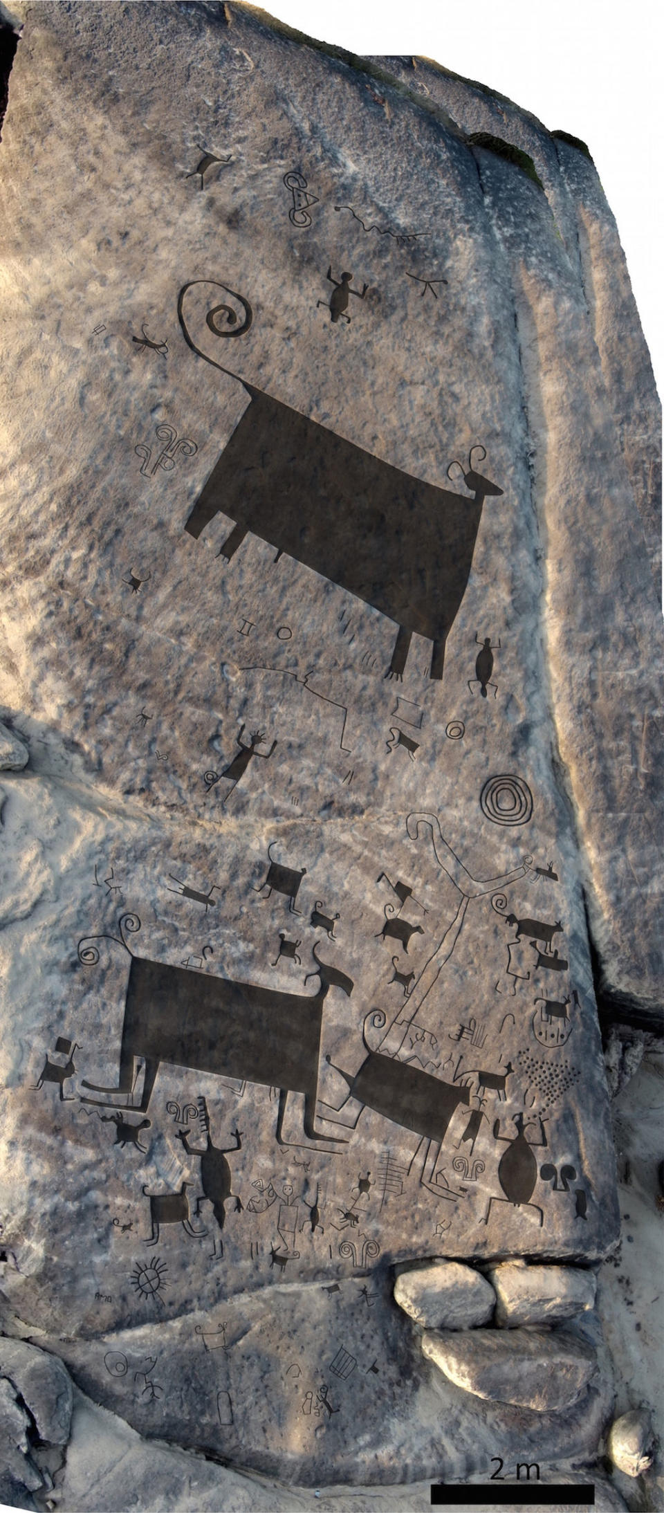 A drone took an image of this panel of rock art. Researchers used a digital overlay to help fill in the images. Note that north is at the bottom of the photo. <cite>Philip Riris, as featured in Antiquity</cite>