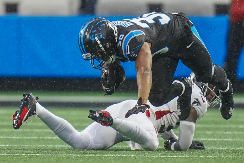 Carolina Panthers running back Chuba Hubbard is tackled by Atlanta Falcons safety DeMarcco Hellams during the first half of an NFL football game Sunday, Dec. 17, 2023, in Charlotte, N.C. (AP Photo/Rusty Jones)
