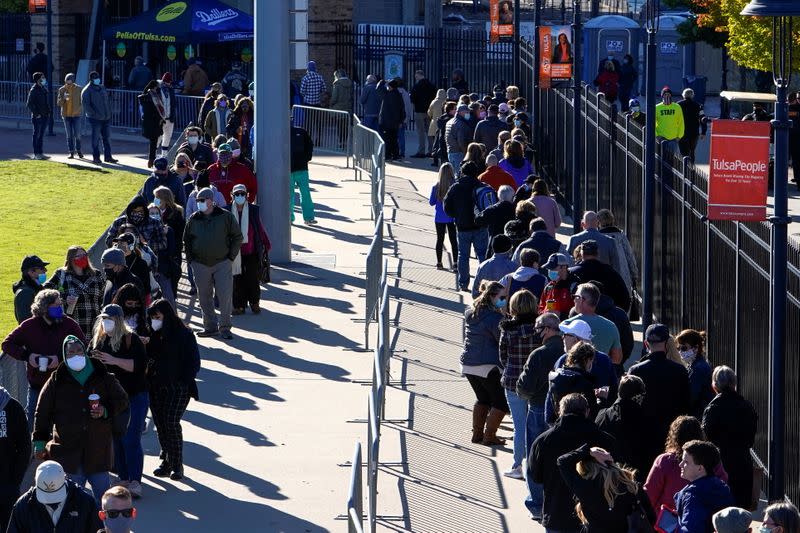 Voters wait in line to cast their ballots during early voting at ONEOK Field in Tulsa