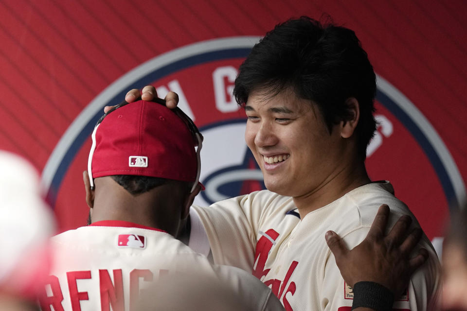 Los Angeles Angels' Shohei Ohtani, right, pats Luis Rengifo on the head prior to a baseball game against the Seattle Mariners Sunday, June 11, 2023, in Anaheim, Calif. (AP Photo/Mark J. Terrill)