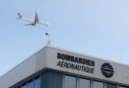 A plane flies over a Bombardier plant in Montreal, Quebec, Canada on January 21, 2014. REUTERS/Christinne Muschi/File Photo