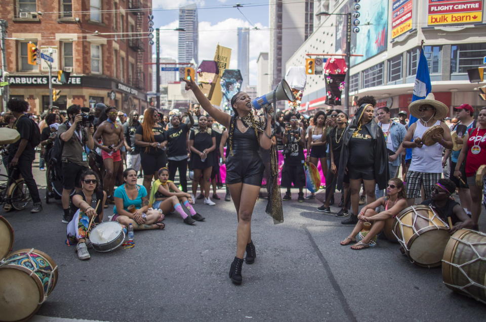 People from the Black Lives Matter sit on the ground to halt the annual Pride Parade, in Toronto on Sunday, July 3, 2016. THE CANADIAN PRESS/Mark Blinch