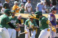 Oakland Athletics' Shea Langeliers (23) celebrates with Seth Brown, left, after hitting a two-run home run against the Texas Rangers during the second inning in the second baseball game of a doubleheader Wednesday, May 8, 2024, in Oakland, Calif. (AP Photo/Godofredo A. Vásquez)