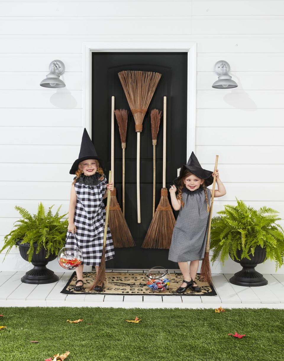 <p>Start a country coven! Gussied up in black-and-white gingham, these sweet witches are ready to cast some serious spells on Halloween night.</p><p><strong>Make the Costumes: </strong>Cut two 31- by 20-inch rectangles from black-and-white gingham fabric. Sew ends together, leaving armholes toward the top of the rectangle. Fold in the top 1 inch of the fabric and sew a channel, leaving a 1-inch opening. Thread a ribbon or string through the channel. Once on, pull the ribbon to gather it at the top. Cut a 3 1/2- by 36-inch strip from black eyelet fabric. Sew a hand-running stitch along the edge of one of the long sides. Leave a knot at one end and pull the string on the other side to create gathers. Pin at the back of the costume or add a snap. Finish with witches hats.</p><p><a class="link " href="https://www.amazon.com/Womens-Costume-Accessory-Halloween-Carnivals/dp/B01LXQ76K1?tag=syn-yahoo-20&ascsubtag=%5Bartid%7C10050.g.28304812%5Bsrc%7Cyahoo-us" rel="nofollow noopener" target="_blank" data-ylk="slk:SHOP WITCHES HATS;elm:context_link;itc:0;sec:content-canvas">SHOP WITCHES HATS</a></p>