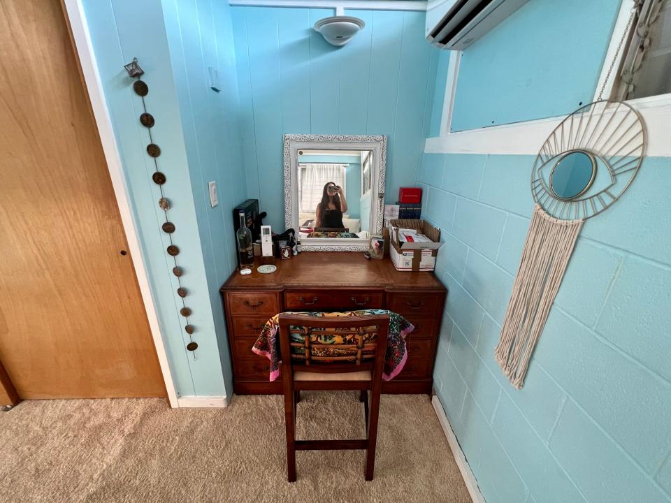dark wood desk on blue wall