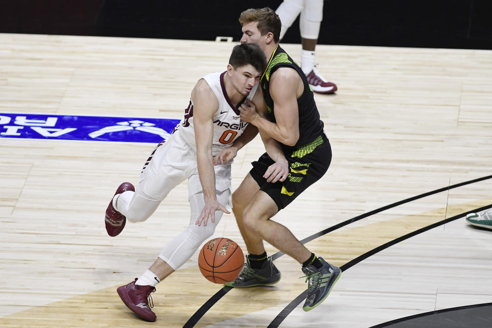 Virginia Tech's Hunter Cattoor, left, is fouled by South Florida's Mark Calleja in the second half of an NCAA college basketball game, Sunday, Nov. 29, 2020, in Uncasville, Conn. (AP Photo/Jessica Hill)