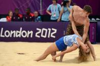 Beach volleyball cheerleaders hit the sand. (David Hecker)