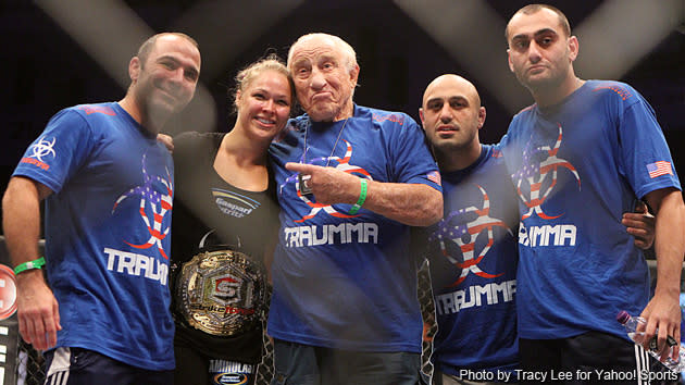 Rousey's entourage celebrates with her in the ring after her win. (Credit: Tracy Lee for Y! Sports)