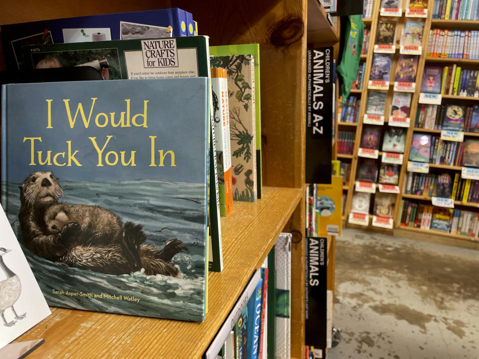 The children's book "I Would Tuck You In," illustrated by Mitchell Thomas Watley, is shown at a bookstore in Portland, Ore. in this April 5, 2023 photo. Publisher Sasquatch books, owned by Penguin Random House, said Wednesday, April 5, 2023, it has ended its publishing relationship with Watley after he was arrested on allegations of leaving violent, transphobic notes in stores around Juneau, Alaska. Watley told police he was motivated by fear following a deadly school shooting in Nashville that sparked online backlash about the shooter's gender identity, court records show. (AP Photo/Claire Rush)