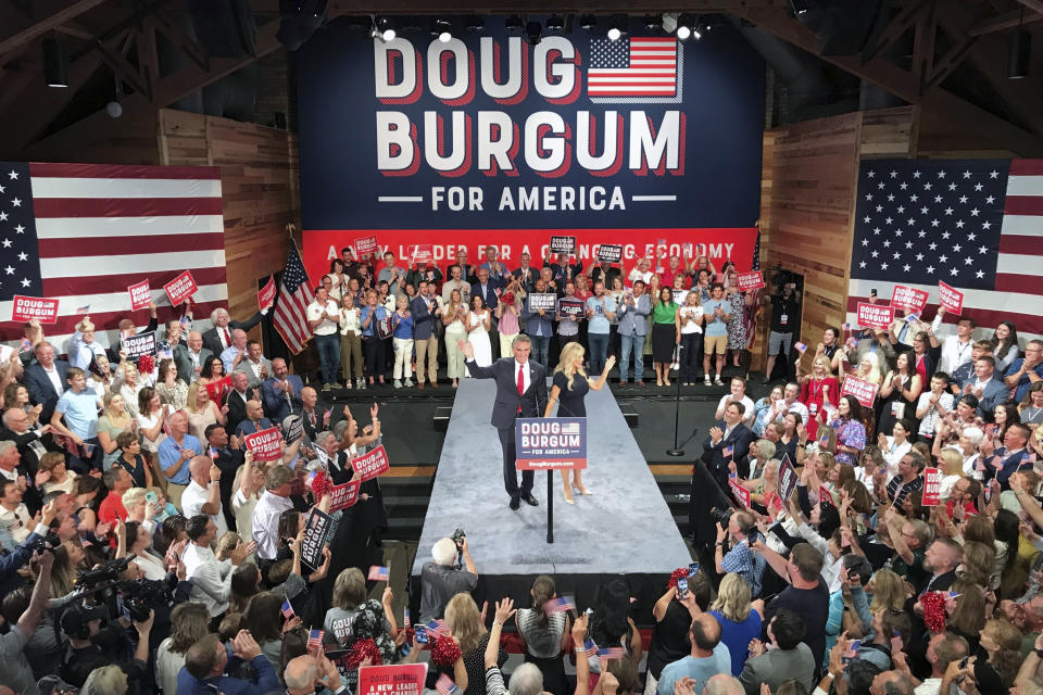 North Dakota Gov. Doug Burgum and first lady Kathryn Burgum, wave to the crowd after he announced his bid for the Republican nomination for President, Wednesday, June 7, 2023, in Fargo, North Dakota. (AP Photo/Jack Dura)