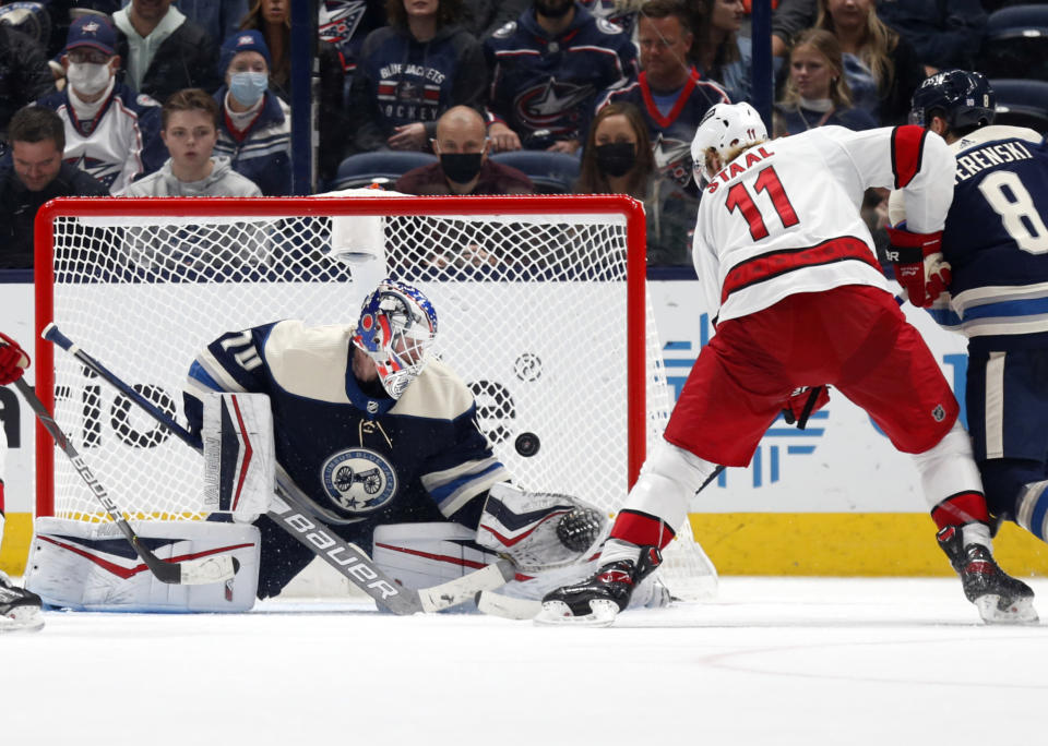 Carolina Hurricanes forward Jordan Staal (11) scores past Columbus Blue Jackets goalie Joonas Korpisalo, left, in front of Blue Jackets defenseman Zach Werenski, right, during the second period of an NHL hockey game in Columbus, Ohio, Saturday, Oct. 23, 2021. (AP Photo/Paul Vernon)