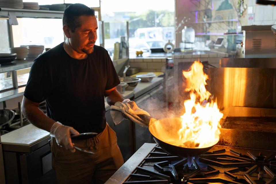 Chef and co-owner Abel Casillas prepares lomo saltado at Las Uvas Restaurant in Modesto, Calif., Thursday, Oct. 5, 2023.