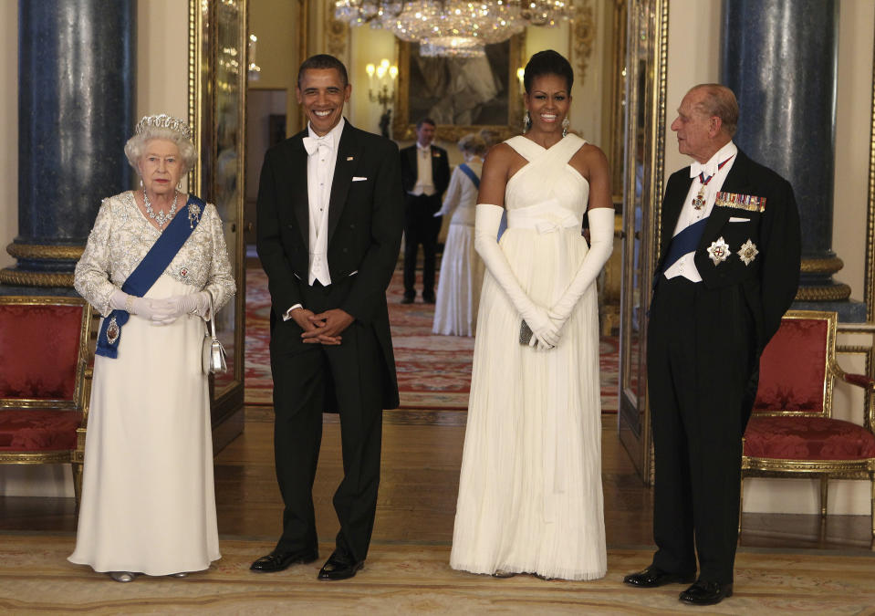 FILE - In this Tuesday May 24, 2011 file photo, Britain's Queen Elizabeth II, U.S. President Barack Obama, first lady Michelle Obama and Prince Philip ahead of a state banquet in Buckingham Palace, London. Buckingham Palace officials say Prince Philip, the husband of Queen Elizabeth II, has died, it was announced on Friday, April 9, 2021. He was 99. Philip spent a month in hospital earlier this year before being released on March 16 to return to Windsor Castle. Philip, also known as the Duke of Edinburgh, married Elizabeth in 1947 and was the longest-serving consort in British history. (AP Photo/Chris Jackson, Pool, File)