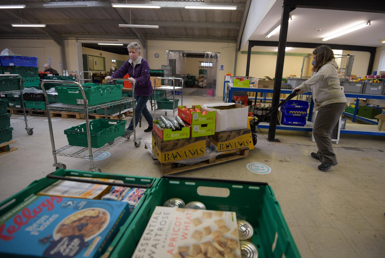 WEYMOUTH, ENGLAND - FEBRUARY 15: Volunteers work in a foodbank sorting hub at an industrial estate, on February 15, 2022 in Weymouth, England. As the UK faces a cost of living crisis, in part due to rising energy and food costs and tax rises, food banks across the country are experiencing increased use of their service. Figures for 2020/21 show approximately 2.5 million people used a foodbank in the United Kingdom, over 600 thousand more than the previous year. The number of foodbank users has increased every year from 26 thousand in 2008/9. (Photo by Finnbarr Webster/Getty Images)