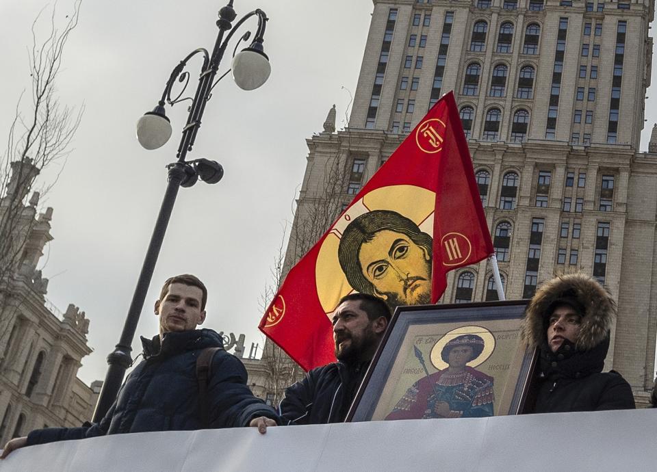 Russian Orthodox Church activists stand in front of Ukraine hotel in a picket to protest the church meeting in Kiev, in Moscow, Russia, Saturday, Dec. 15, 2018. Thousands of people have gathered outside a Kiev cathedral to witness the birth of a new Ukrainian Orthodox Church as tensions between Ukraine and Russia continue to drive the two farther apart. (AP Photo/Dmitry Serebryakov)