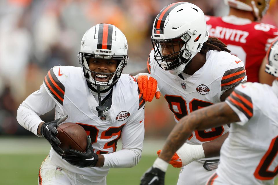 Cleveland Browns cornerback Martin Emerson Jr., left, is congratulated by defensive end Za'Darius Smith after intercepting a pass against the San Francisco 49ers on Sunday in Cleveland.