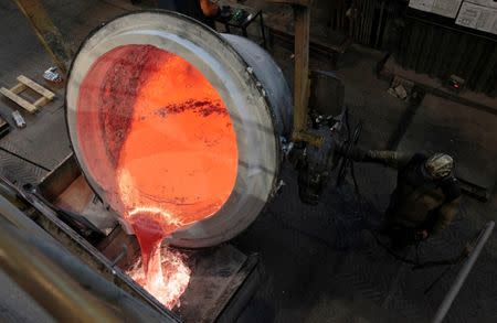 A worker operates a mixer of fused aluminium at the foundry shop of the Rusal Krasnoyarsk aluminium smelter in the Siberian city of Krasnoyarsk August 14, 2012. REUTERS/Ilya Naymushin