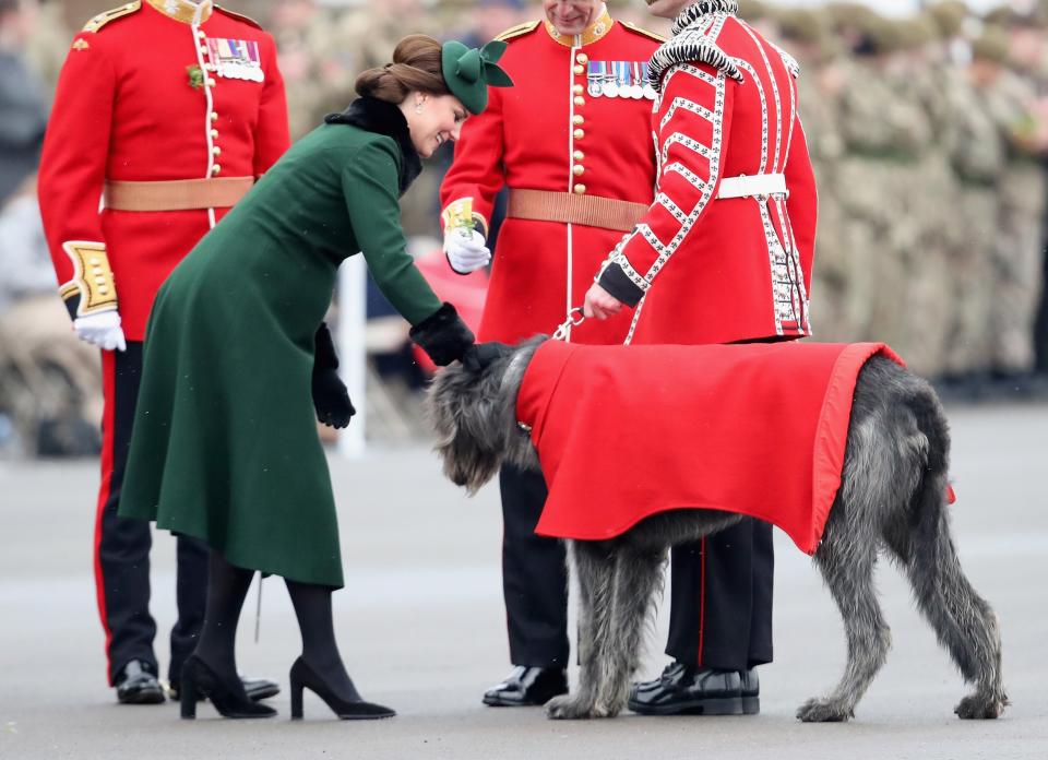 Kate Middleton, in a green Catherine Walker coat, and Prince William celebrated St. Patrick's Day in west London with the 1st Battalion of the Guards regiment.