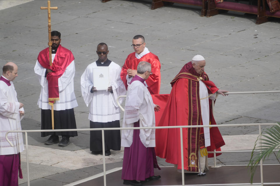 Pope Francis climbs on the altar where he will celebrate the Palm Sunday's mass in St. Peter's Square at The Vatican Sunday, April 2, 2023 a day after being discharged from the Agostino Gemelli University Hospital in Rome, where he has been treated for bronchitis, The Vatican said. The Roman Catholic Church enters Holy Week, retracing the story of the crucifixion of Jesus and his resurrection three days later on Easter Sunday. (AP Photo/Gregorio Borgia)