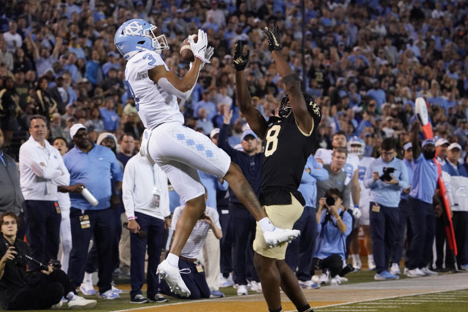 North Carolina wide receiver Antoine Green catches a touchdown pass against Wake Forest defensive back Isaiah Wingfield (8) during the first half of an NCAA college football game in Winston-Salem, N.C., Saturday, Nov. 12, 2022. (AP Photo/Chuck Burton)