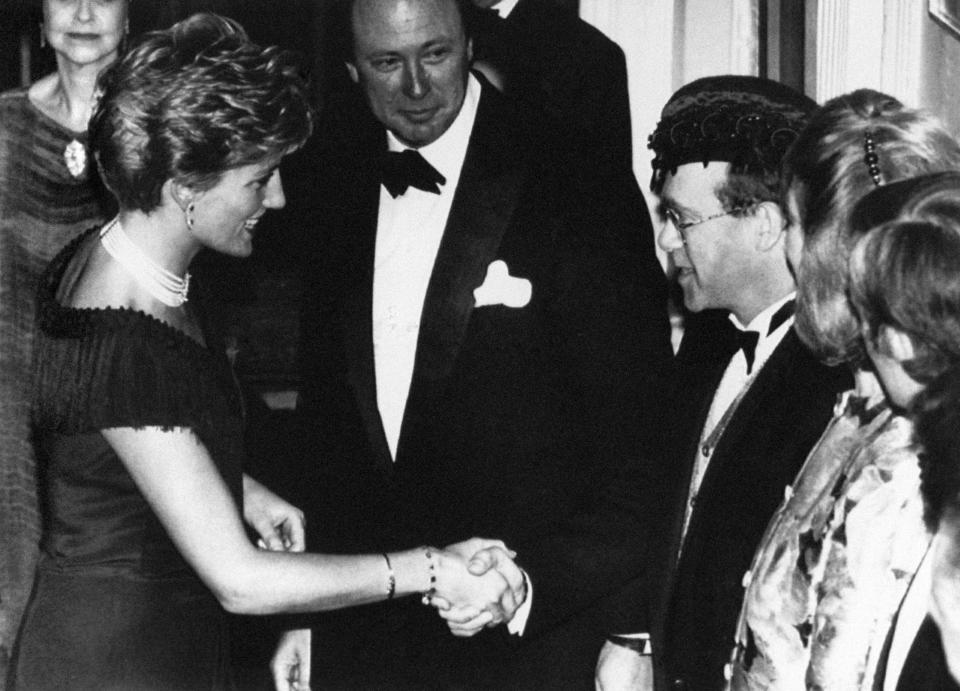 The Princess of Wales is greeted by singer Elton John for the charity premiere in aid of National Aids Trust   (Photo by PA Images via Getty Images)