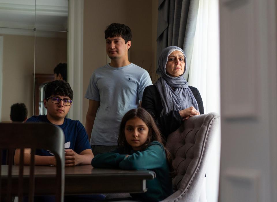(From right, clockwise) Amnah Allboani Ghanem stands in her home in West Bloomfield with her daughter, Haneen, and sons Zied and Yaser, on Wednesday, May 15, 2024. Allboani Ghanem's husband, Dr. Ammar Ghanem of West Bloomfield, was stuck in Gaza after finishing a volunteer medical mission.
