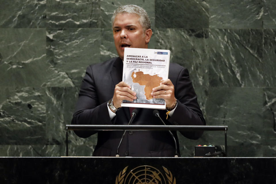 Colombia's President Ivan Duque holds a book as he addresses the 74th session of the United Nations General Assembly, Wednesday, Sept. 25, 2019. (AP Photo/Richard Drew)
