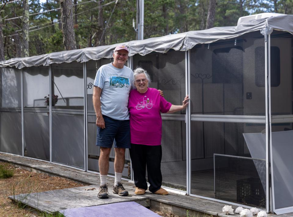 Maurice's Campground co-owner John Gauthier, left, and Melinda Brotherton, 85, right, pose in front of her trailer at the campground in South Wellfleet. This summer marked the seventh year Brotherton had stayed at the campground.