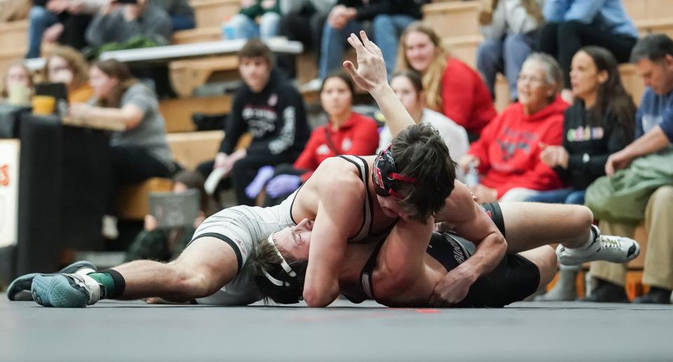 Edgewood’s John Orman (top) wrestles against Bloomington South’s Nolan Langley in the 120-pound match during their dual meet at Edgewood on Thursday, Jan. 18, 2024.