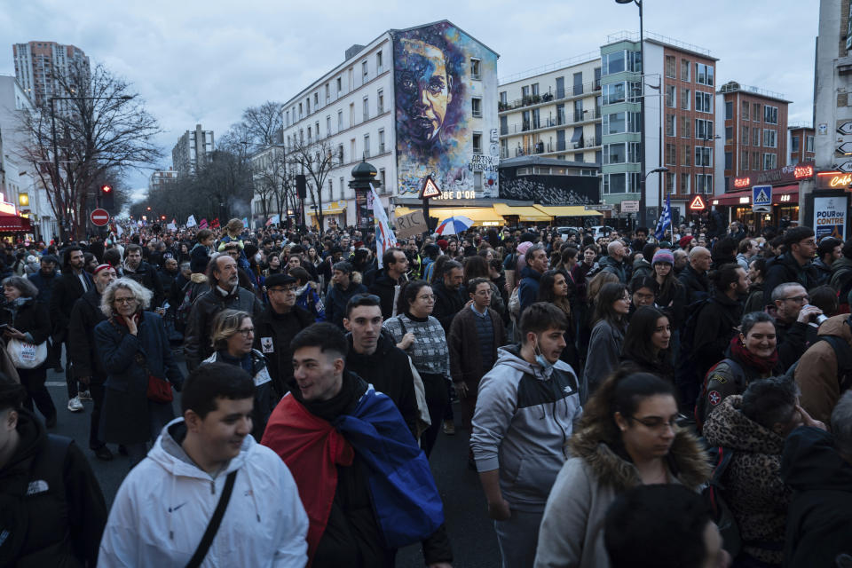 People march during a protest in Paris, Saturday, March 18, 2023. A spattering of protests were planned to continue in France over the weekend against President Macron's controversial pension reform, as garbage continued to reek in the streets of Paris and beyond owing to continuing action by refuse collectors. (AP Photo/Lewis Joly)