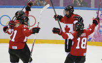 Brianne Jenner of Canada (19) celebrates her goal against the United States with her teammates Haley Irwin (21) and Catherine Ward (18) during the third period of the women's gold medal ice hockey game at the 2014 Winter Olympics, Thursday, Feb. 20, 2014, in Sochi, Russia. (AP Photo/Petr David Josek)