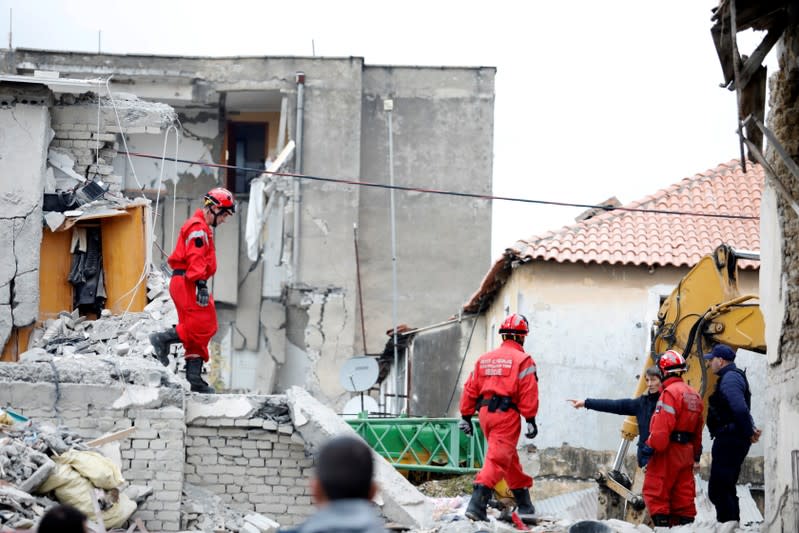 El personal de emergencia camina sobre los escombros de los edificios derrumbados y dañados tras el poderoso terremoto del martes en Thumane, Albania, el 27 de noviembre de 2019