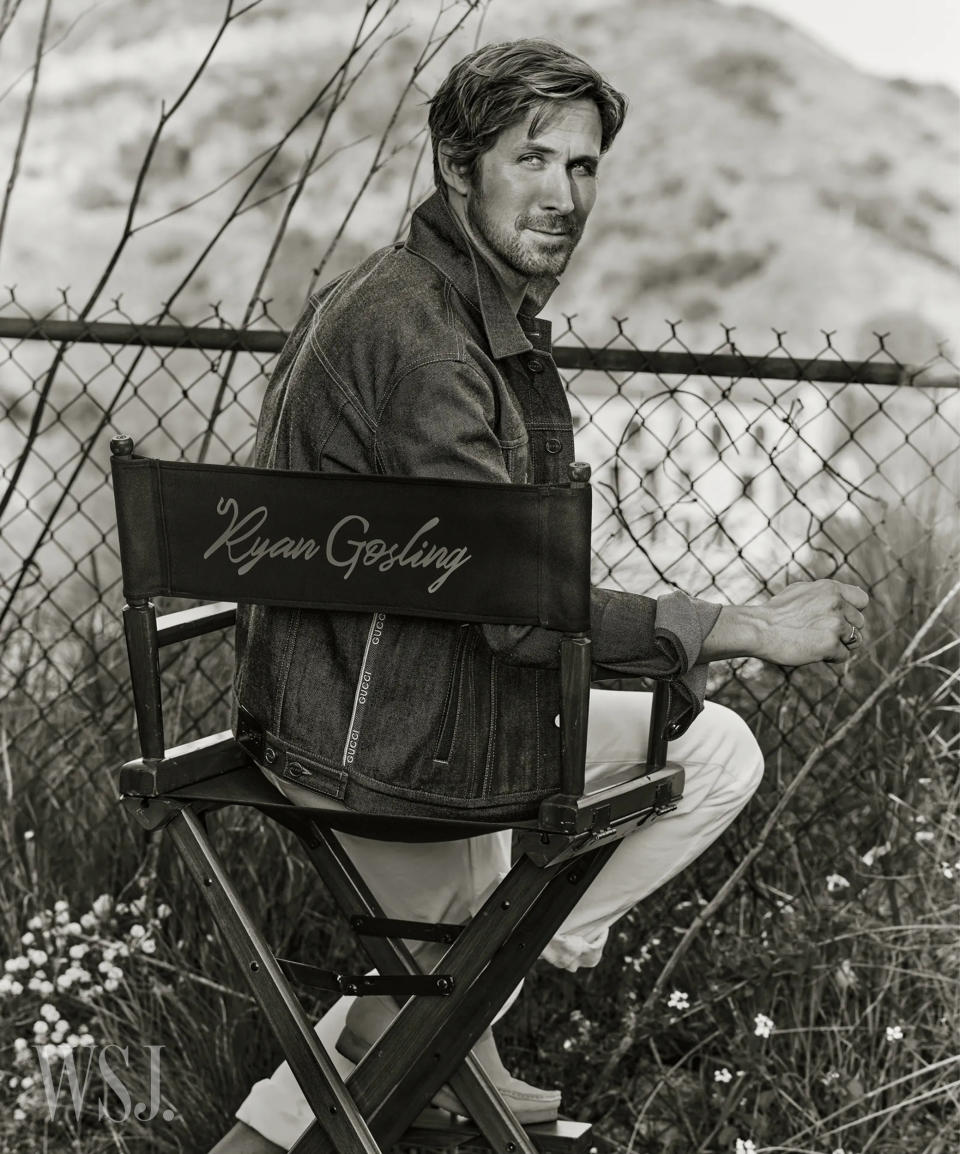 Ryan Gosling sitting in a chair with his name on it