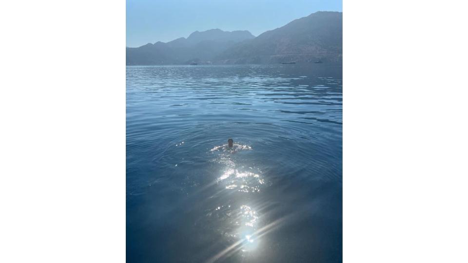 man swimming in sea 