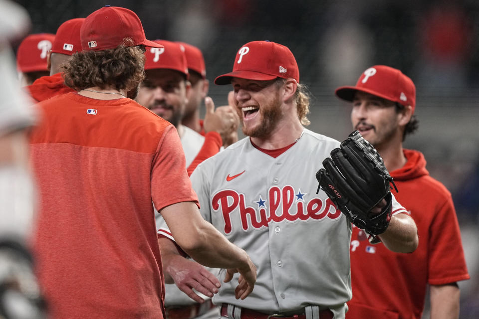 Philadelphia Phillies relief pitcher Craig Kimbrel, center, celebrates with teammates after a baseball game against the Atlanta Braves, Friday, May 26, 2023, in Atlanta. Kimbrel celebrated his 400th career save. (AP Photo/Brynn Anderson)